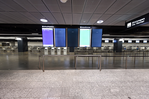 The Zurich Airport ZRH during the Corona Pandemic (COVID-19). Inside view of the departure Hall to Gate B captured during the siwsswide Lockdown. Arrival and Departure Board almost empty.