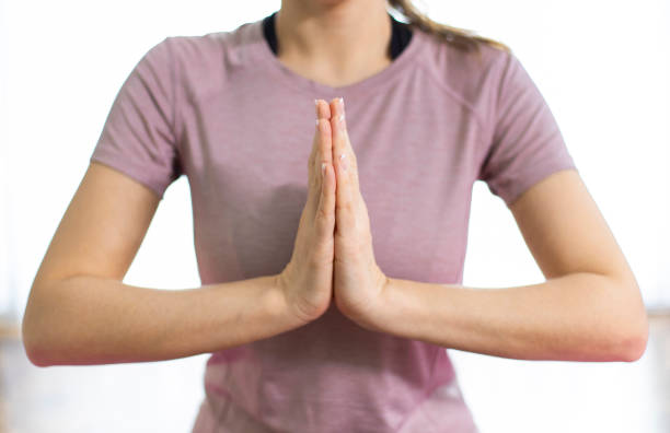 istock Yogi woman doing namaste gesture at home 1224310353