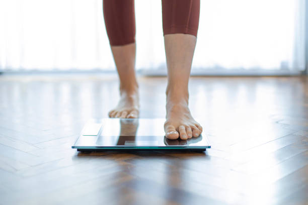 istock Young woman on home scales 1224310371
