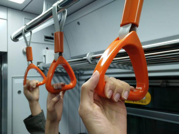 istock Three people hold handles firmly on train 1224311250