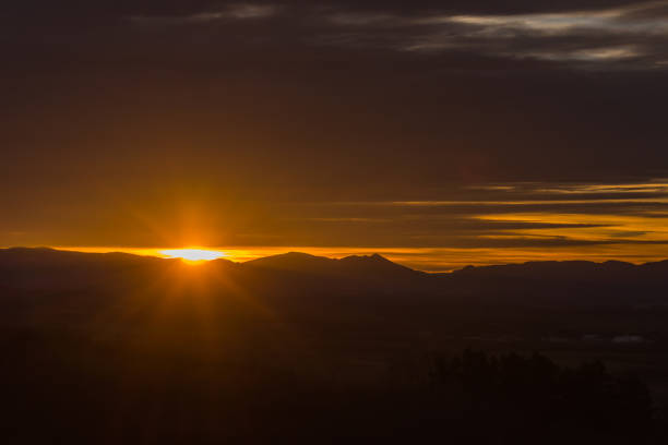 istock bright glowing sun with mountains and clouds 1224311502