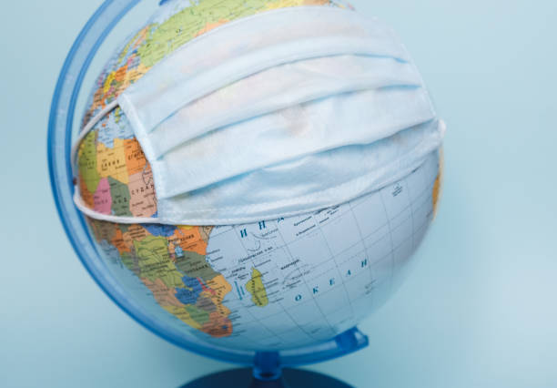 istock protective medical mask on a globe close-up 1224313281