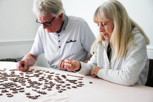 istock Senior couple doing jigsaw puzzle together at home 1224313285