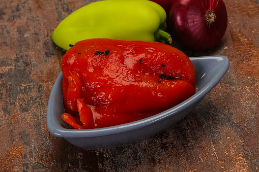 Marinated baked red bell pepper in the bowl