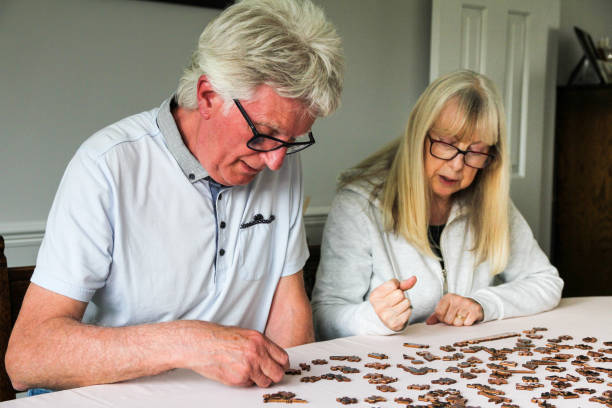 istock Senior couple doing jigsaw puzzle together at home 1224313303