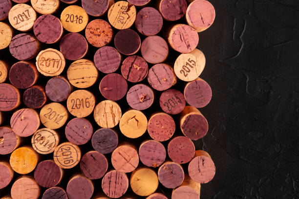 istock Wine corks background, a design template for a restaurant menu or winery brochure, shot from above with copy space on a dark background 1224316207