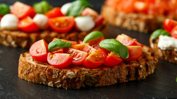 istock Bruschetta with cherry tomato and basil on rustic stone board 1224316343
