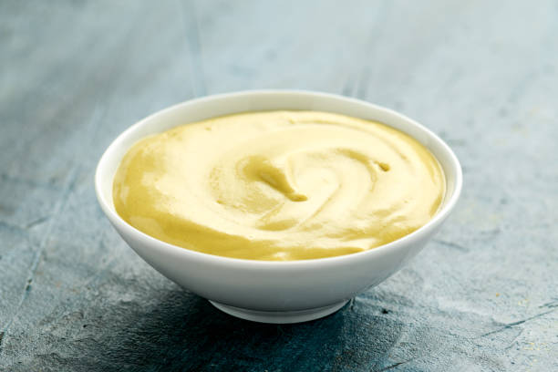 istock Dijon mustard in white bowl on rustic background 1224316608