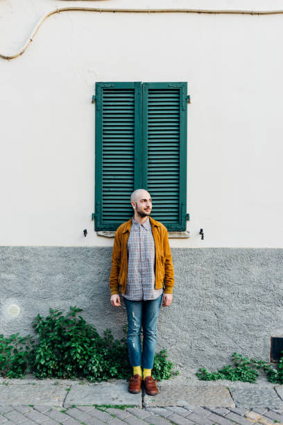 istock young gay man overlooking pensive posing leaning wall 1224316865