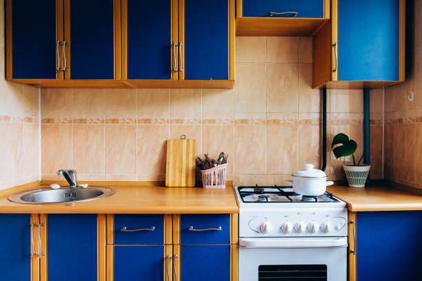 Old simple kitchen interior design with ugly messy cabinets in need of remodel.