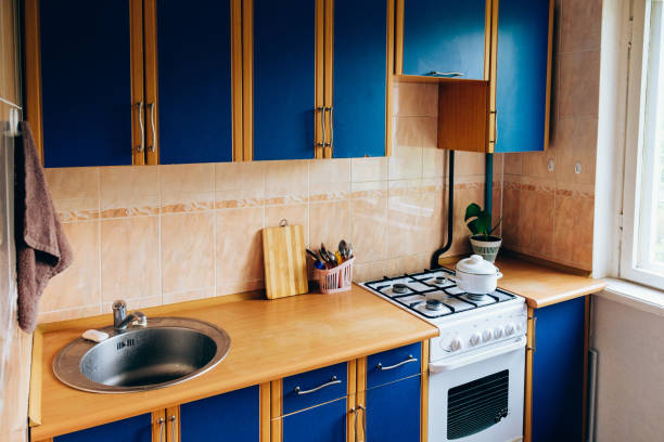 istock Retro simple kitchen interior design with ugly messy cabinets in need of remodel. 1224318114
