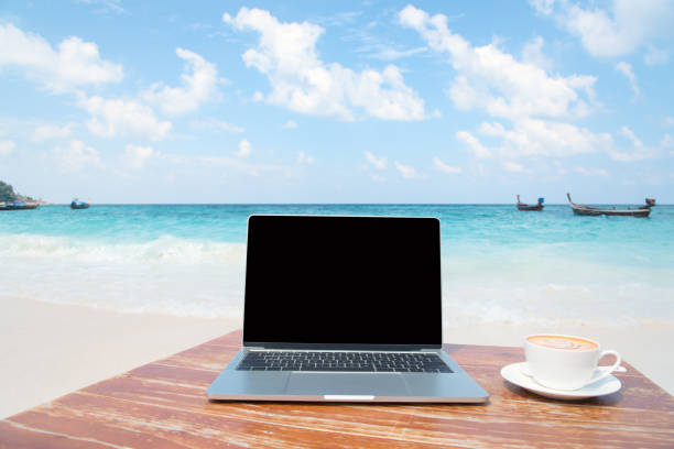 istock Mobile work office on the beach with blank laptop screen 1224319540