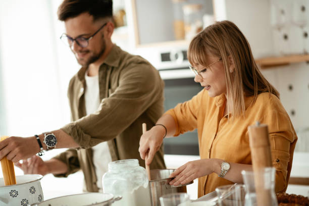 istock Young couple cooking together at home 1224319652