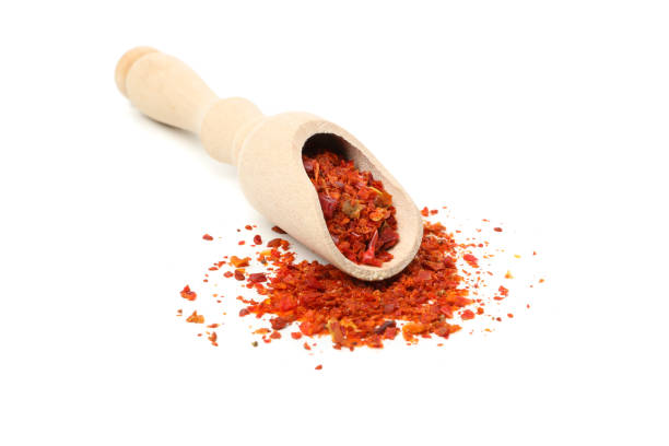 istock Wooden scoop with pepper spice isolated on white background 1224320624