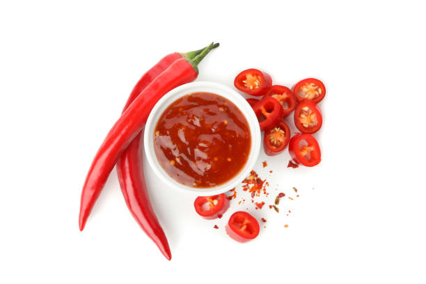 istock Chilli pepper and bowl of sauce isolated on white background 1224320859