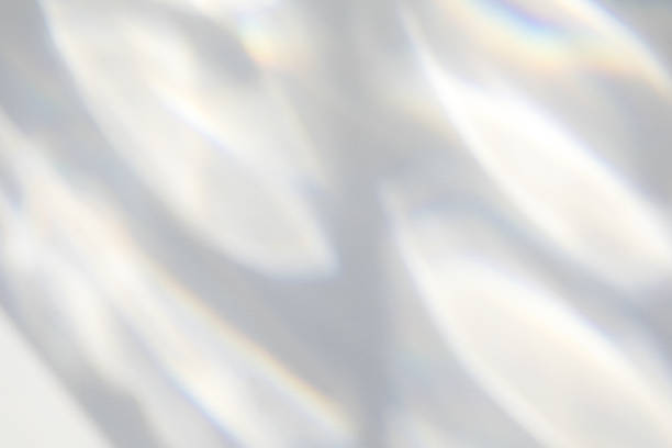 Organic drop shadow on a white wall Geometric texture overlay effect for photo and mockups. Organic drop diagonal shadow and light caustic effect on a white wall. black glass surface stock pictures, royalty-free photos & images