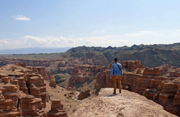 istock Man standing on a rock in Charyn Canyon, Kazakhstan 1224321986