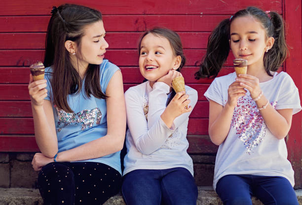 istock Girlfriends are eating ice cream and making fun together 1224323508