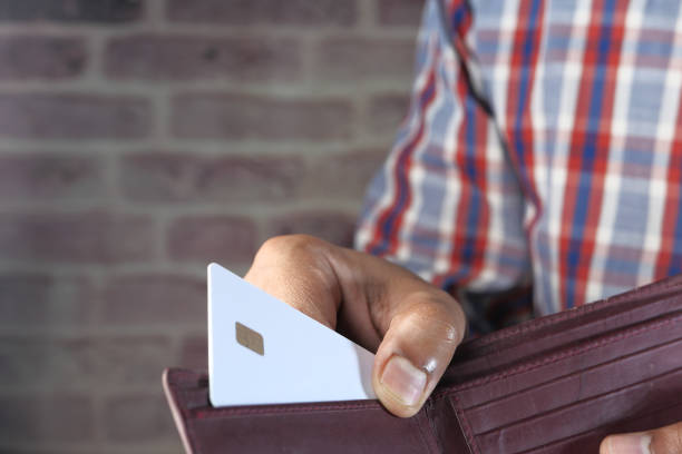 istock man taking credit card from black wallet 1224323891