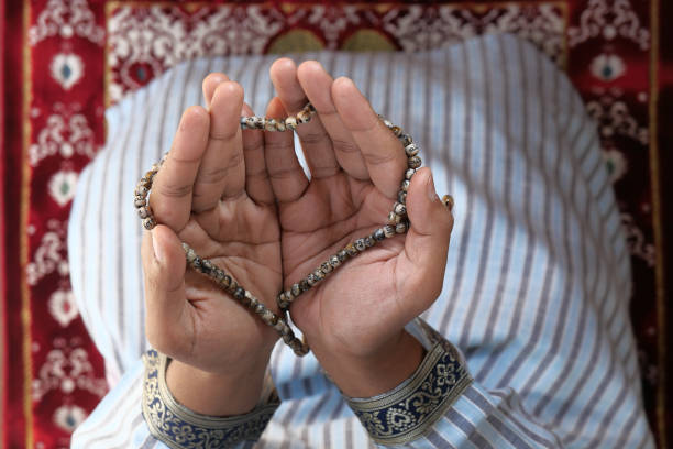 istock high angle view of muslim man hand praying for ramadan 1224324654