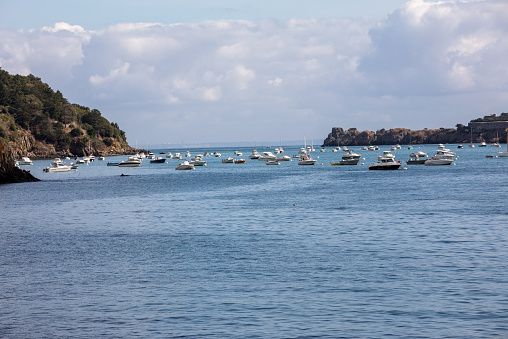 Cancale, France - September 15, 2018: Fishing boats and yachts moored in the bay at high tide in Cancale, famous oysters production town. Brittany, France,