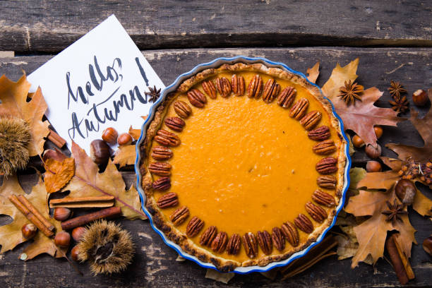 istock Pumpkin Pie with pecan nut and cinnamon on rustic background, top view, copy space. Homemade autumn pastry for Thanksgiving 1224329884