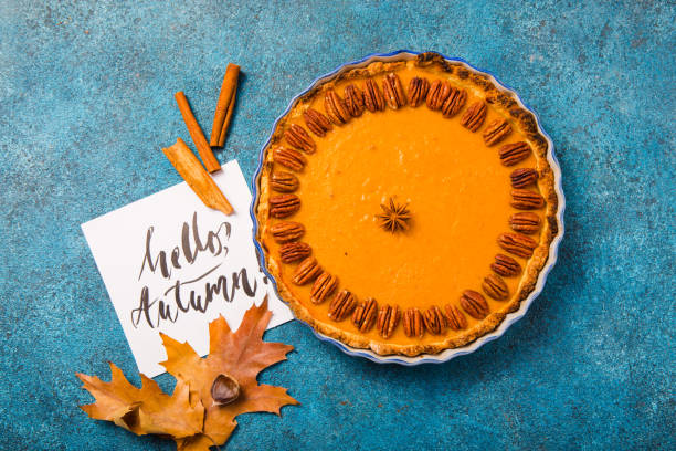 istock Pumpkin Pie and slice  with pecan nut and cinnamon on blue concrete background, top view, copy space. Homemade autumn pastry for Thanksgiving 1224330421