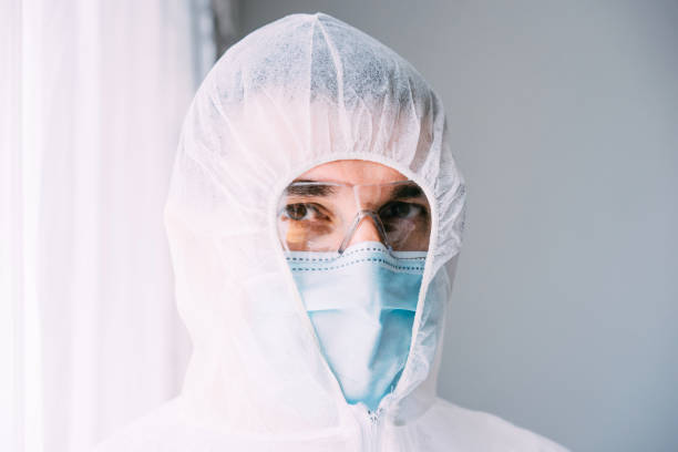 istock Man doctor or scientist wearing protective suit, and face mask 1224331072