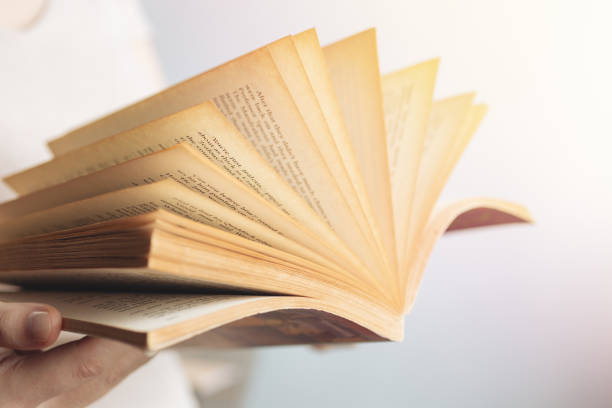 istock Vintage close up of an old open book with yellow pages. Avid reader, bookworm concept 1224331123