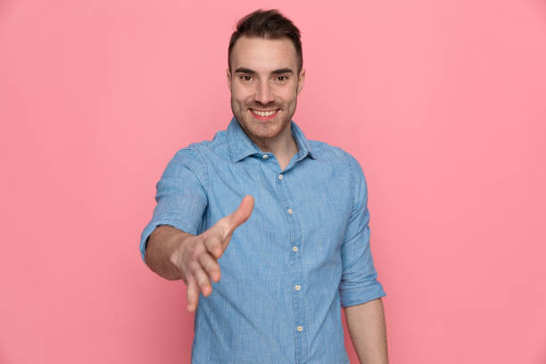 istock casual man extending his hand, ready for shaking hands 1224332071