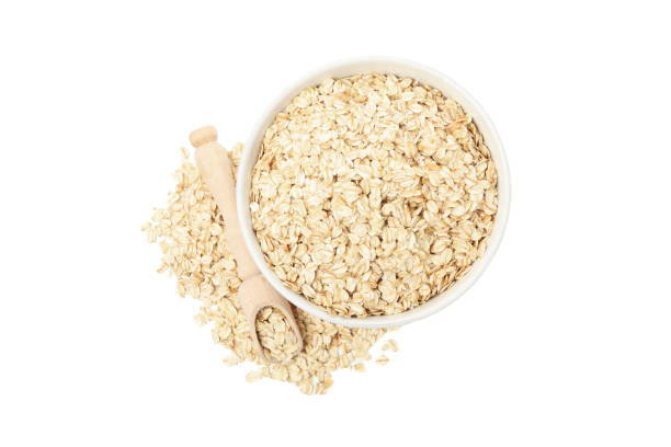 istock Bowl and scoop with oatmeal flakes isolated on white background 1224332138