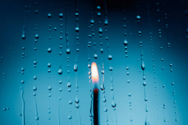 Water drops in front of candle