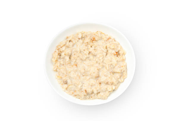 istock Plate with cooked oatmeal isolated on white background 1224332524