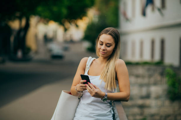 istock Woman using smartphone in the city 1224332764