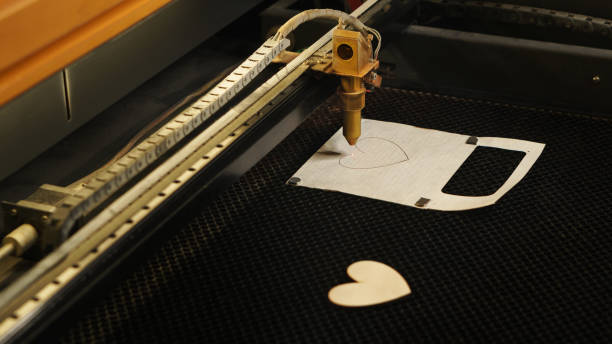istock Laser cutting beam over plywood sheet 1224333013