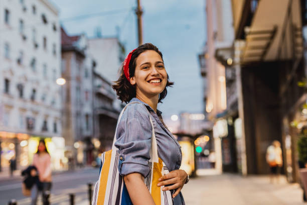 istock Smiling woman with reusable shopping bag 1224334083