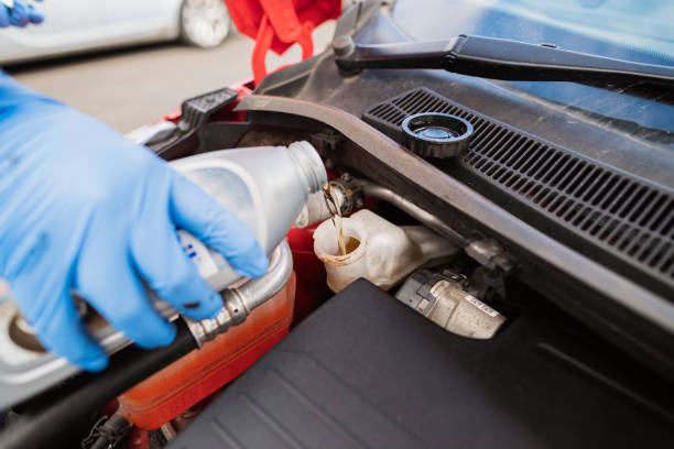 Adding Brake Fluid Close-up of an unrecognisable young caucasian man adding brake fluid to a car. brake stock pictures, royalty-free photos & images