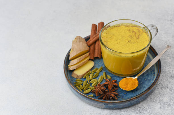 istock A glass cup with golden milk and ingredients around with copy space. 1224339515