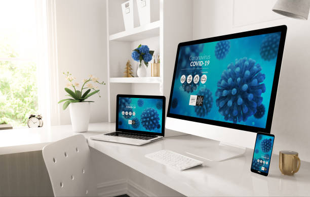istock responsive devices on home desktop showing covid-19 info website 1224339522