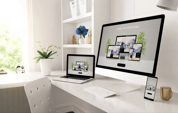 Photo of responsive devices on home desktop showing web design website