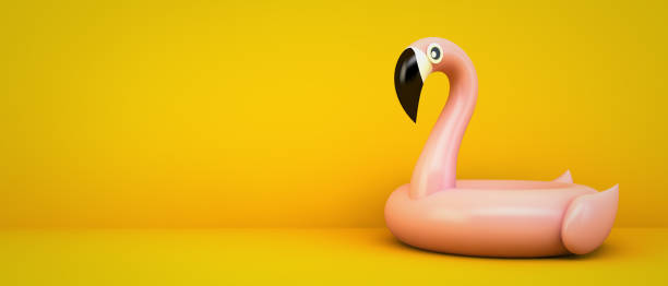 istock pink flamingo on yellow background 1224341180
