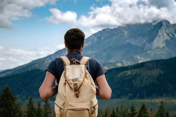 istock Man hiking at mountains with heavy backpack 1224341505