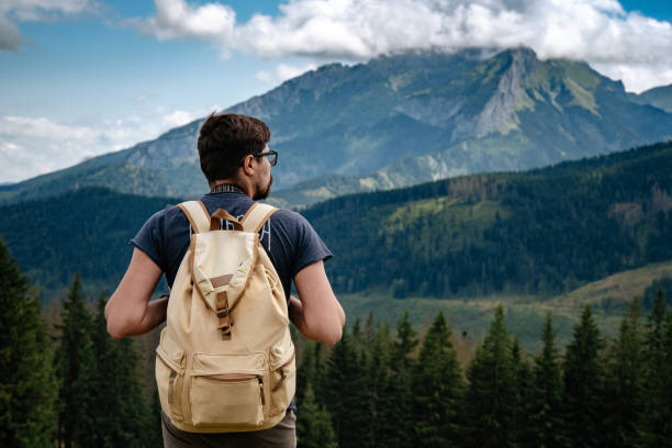 istock Man hiking at mountains with heavy backpack 1224341535