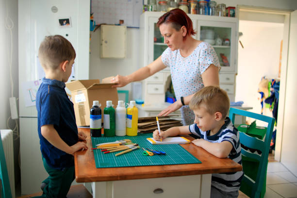 istock Mom and kids making a cardboard dinosaur costume 1224343367