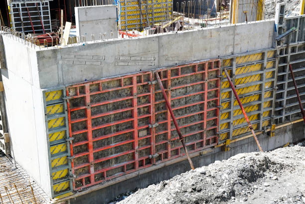 large construction site with a subfloor cellar in concrete and shuttering panels in place Felsberg, GR / Switzerland - 2 May 2020: large construction site with a subfloor cellar in concrete and shuttering panels in place concrete in formwork stock pictures, royalty-free photos & images
