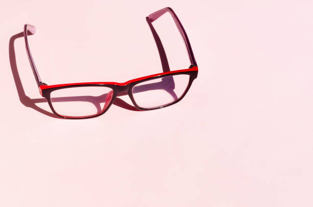 istock Eyeglass on pink background with shadows 1224346781