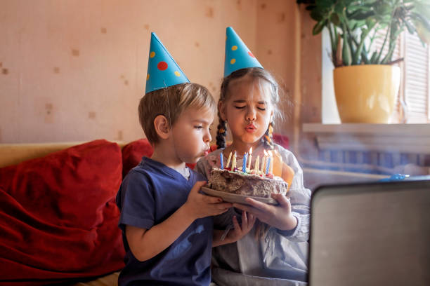 Happy father with two sibling celebrating birthday via internet in quarantine time, self-isolation Happy family with two sibling celebrating birthday via internet in quarantine time, self-isolation and family values, online birthday party virtual birthday celebration stock pictures, royalty-free photos & images