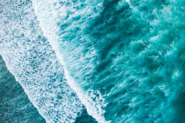 istock Big ocean waves hitting a coral rif. View from above. 1224351650