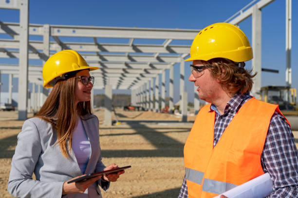 istock Young Female Architect with Digital Tablet and Engineer Having Conversation at Construction Site 1224352245
