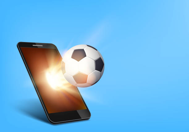 istock Soccer ball on fire flies out of the smartphone screen. 1224353066